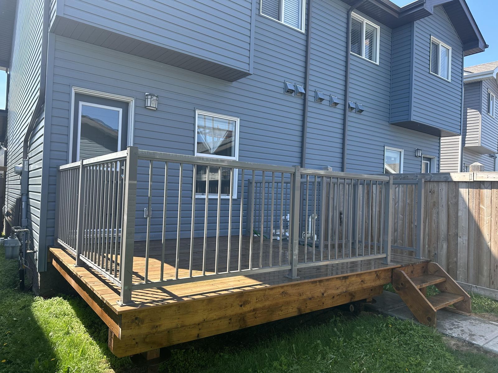 Custom deck with metal railing Edmonton — TrueBlue Builders Ltd